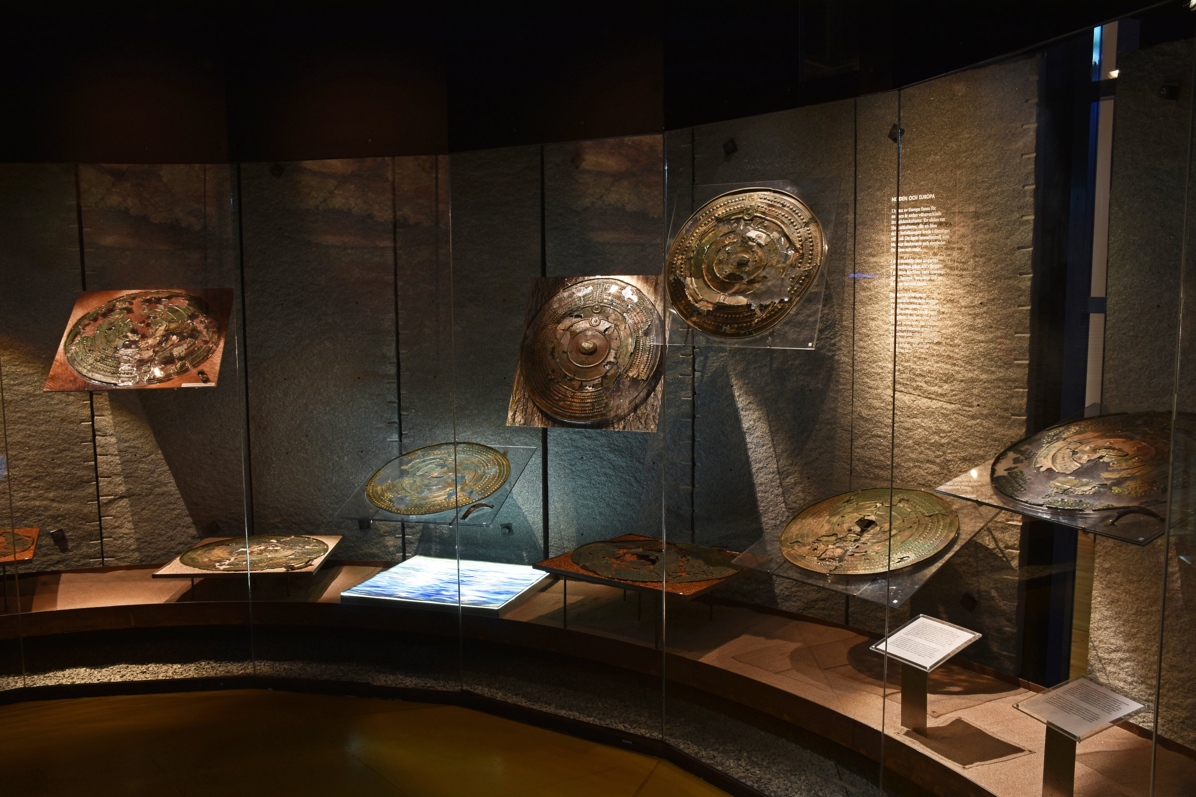 Bronze shields behind glass
